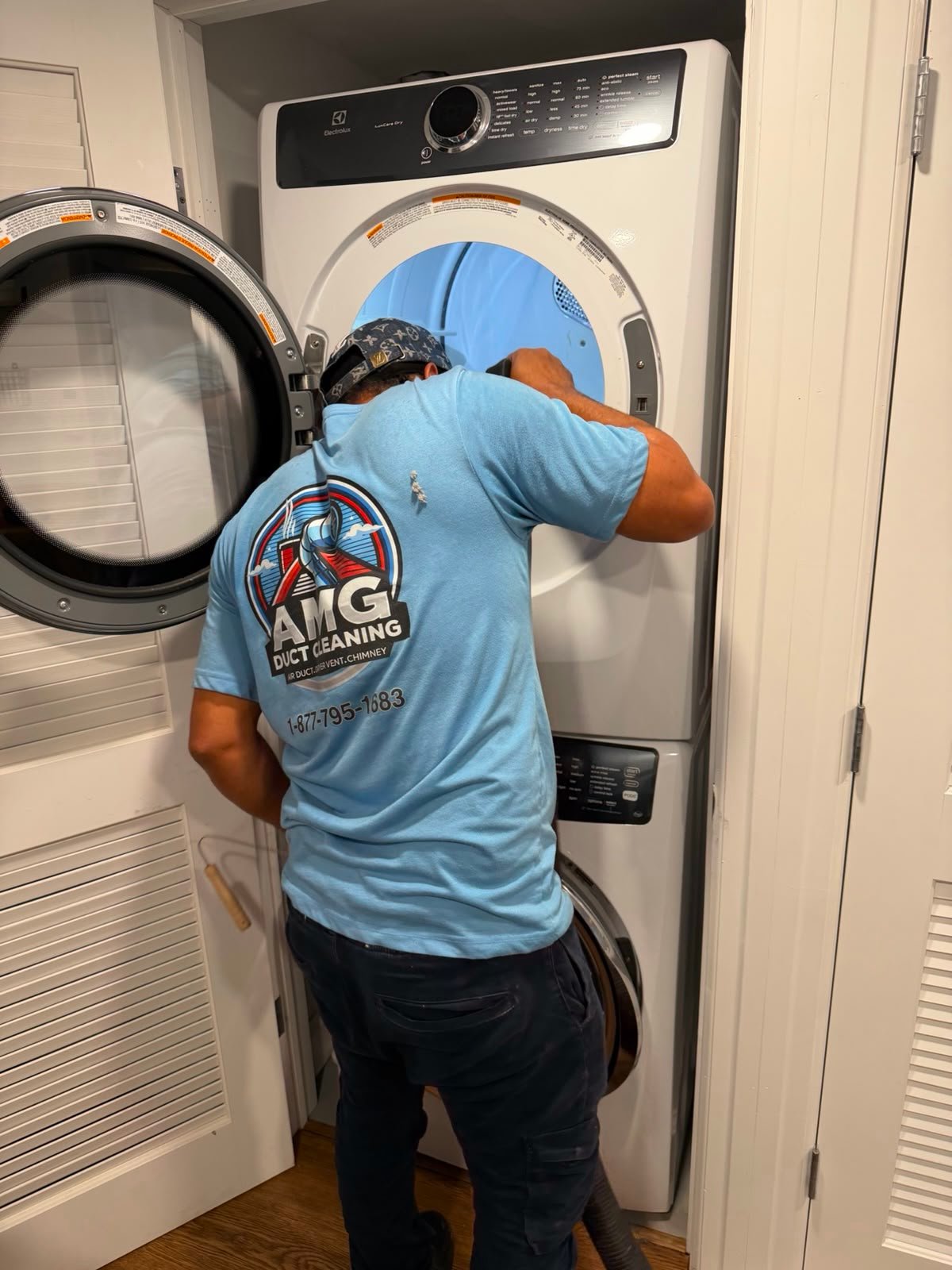 An AMG technician cleaning a home dryer vent
