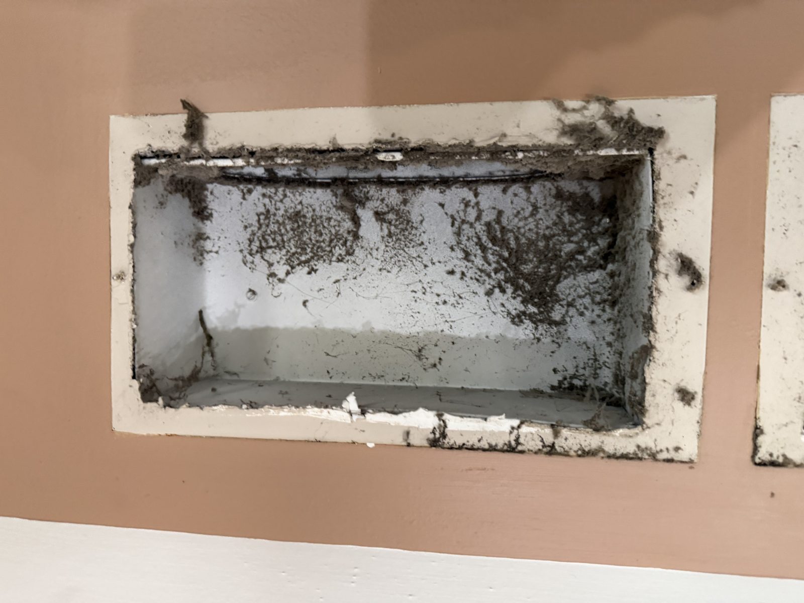 A dust filled rectangular duct before cleaning