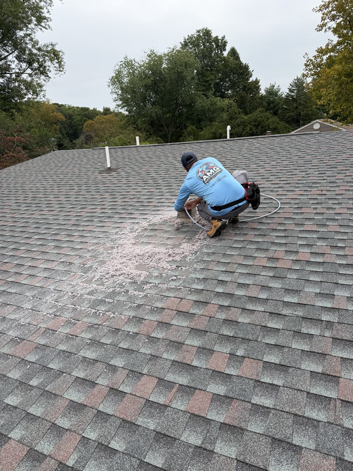 An AMG technician working on a New Jersey roof