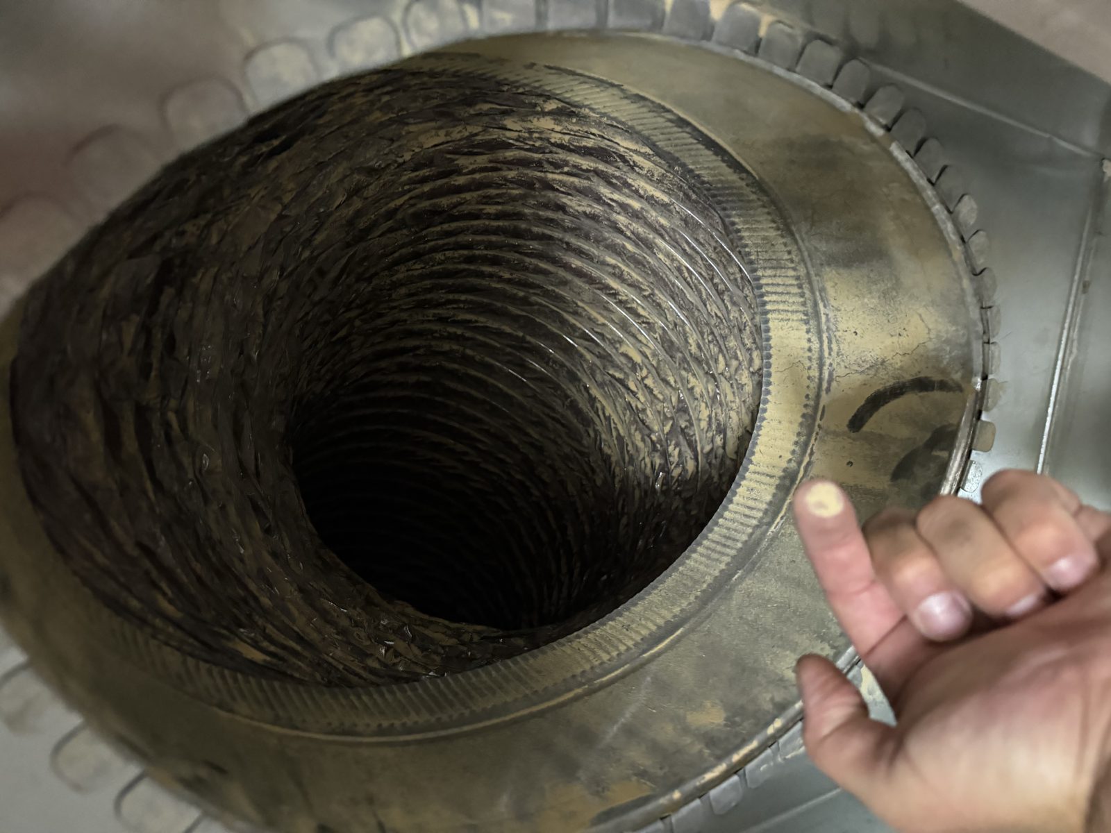 The inside of a metal duct cleaned by AMG