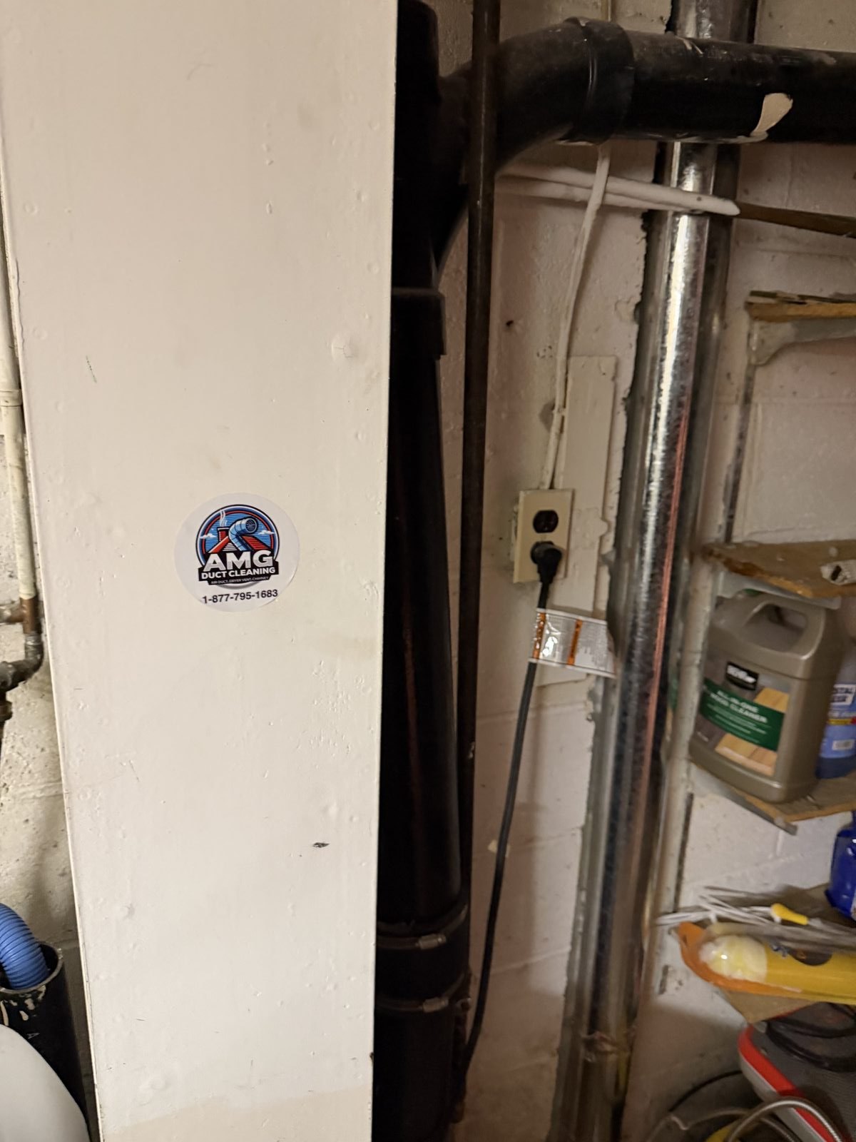 Dryer exhaust pipes serviced by AMG in a garage