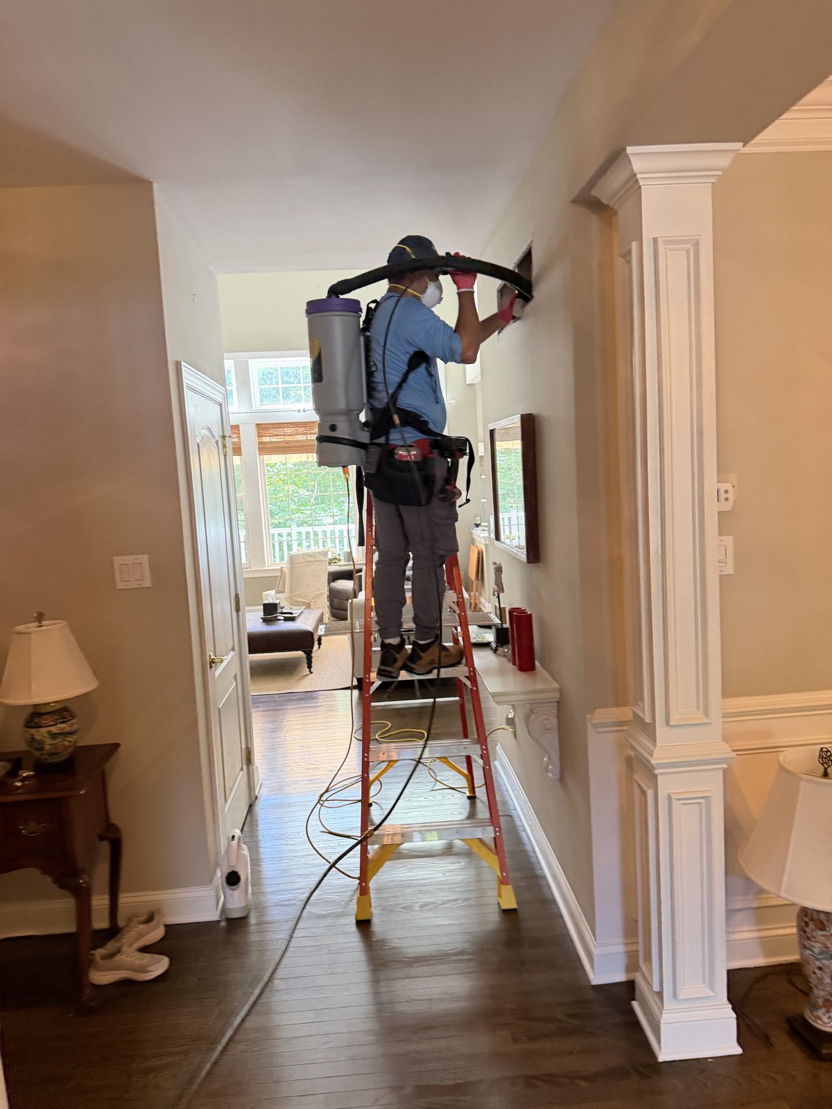 An AMG technician cleaning a vent in a New Jersey home